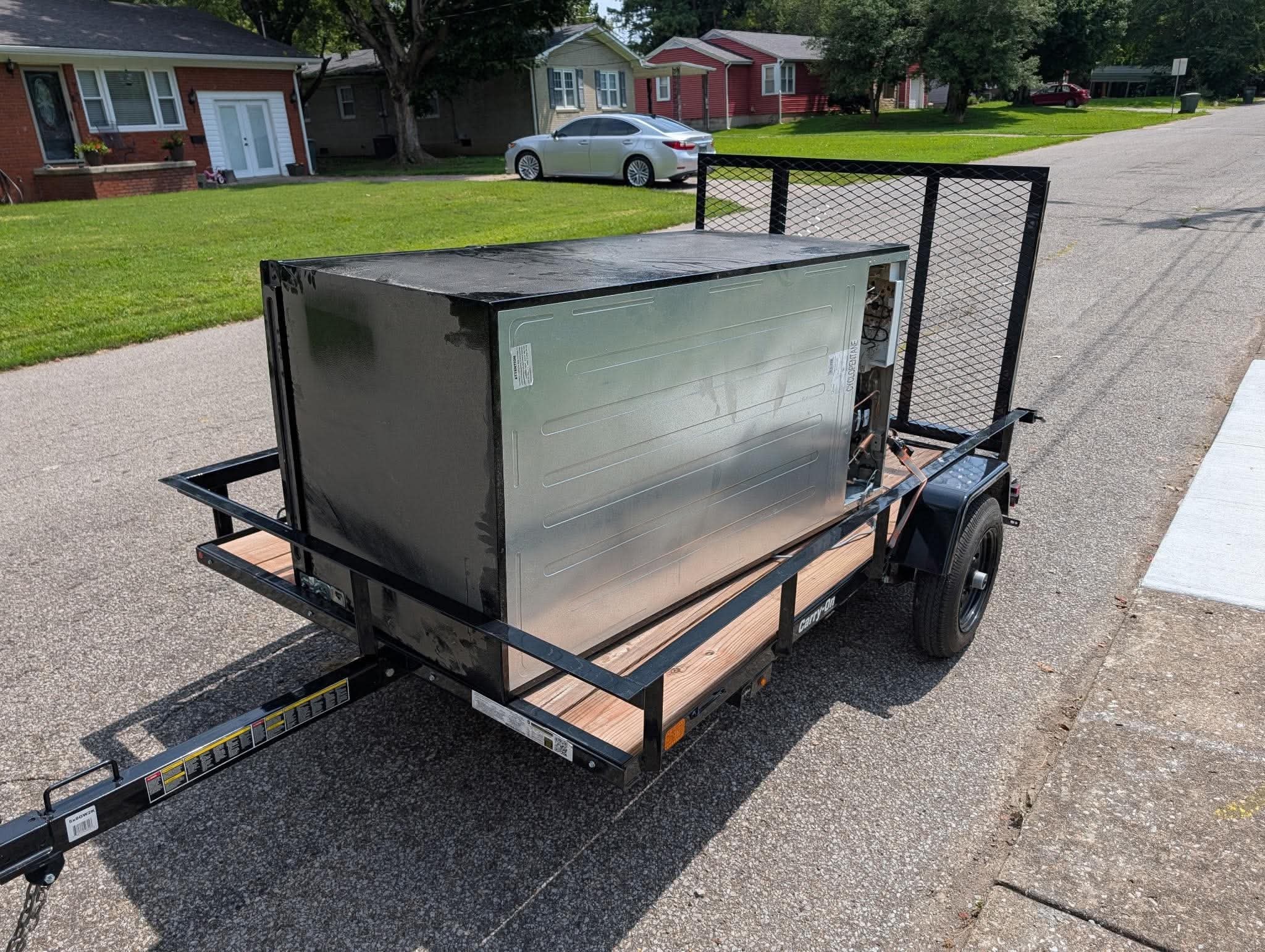 Old refrigerator loaded on a utility trailer for appliance removal in Madisonville KY