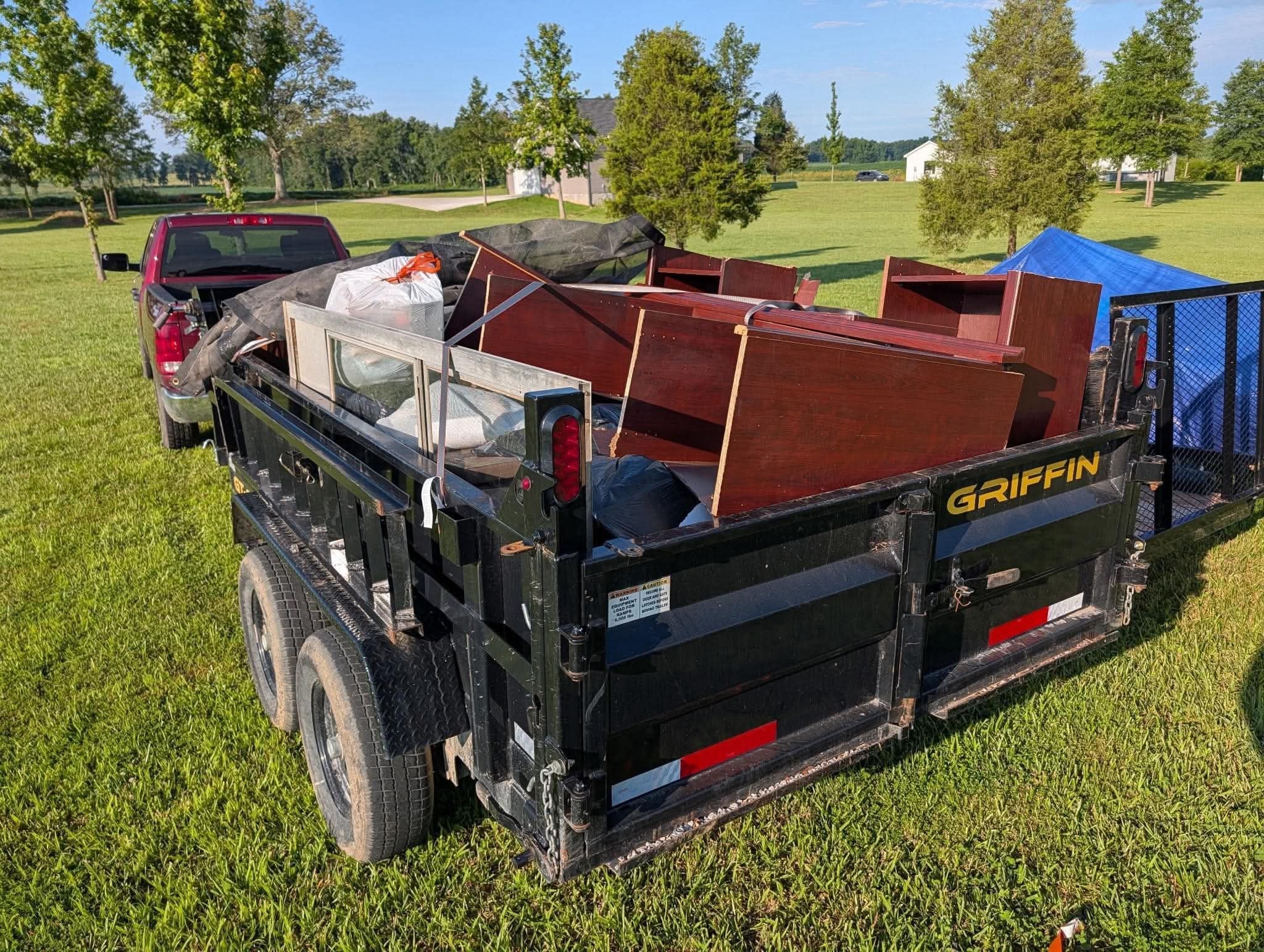 Griffin dump trailer loaded with furniture and junk after a property cleanout